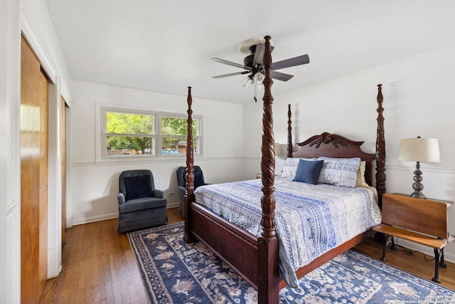 bedroom with a closet, hardwood / wood-style flooring, and ceiling fan