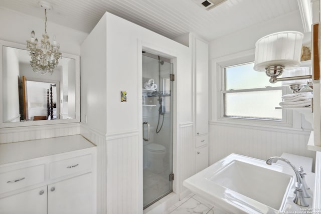 bathroom with walk in shower, wooden walls, sink, an inviting chandelier, and toilet