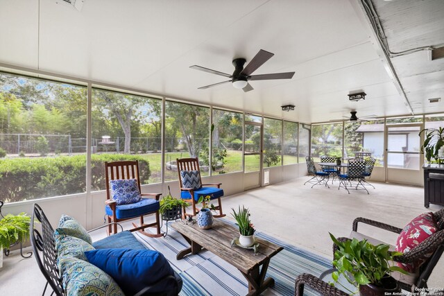 sunroom / solarium featuring ceiling fan