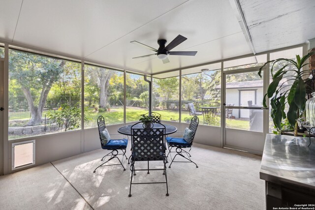 sunroom / solarium featuring a wealth of natural light and ceiling fan