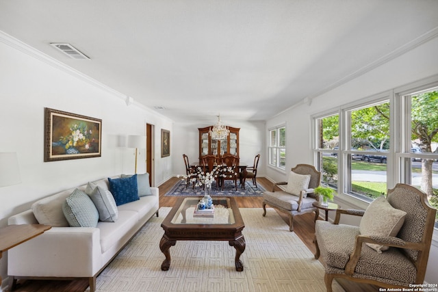 living room featuring crown molding and light hardwood / wood-style floors