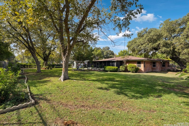 view of yard featuring a sunroom