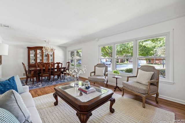 living room featuring light hardwood / wood-style floors and an inviting chandelier