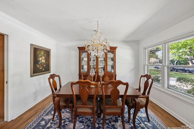 dining space with a notable chandelier, dark hardwood / wood-style floors, and crown molding