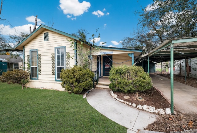 bungalow-style home featuring a front yard and a carport