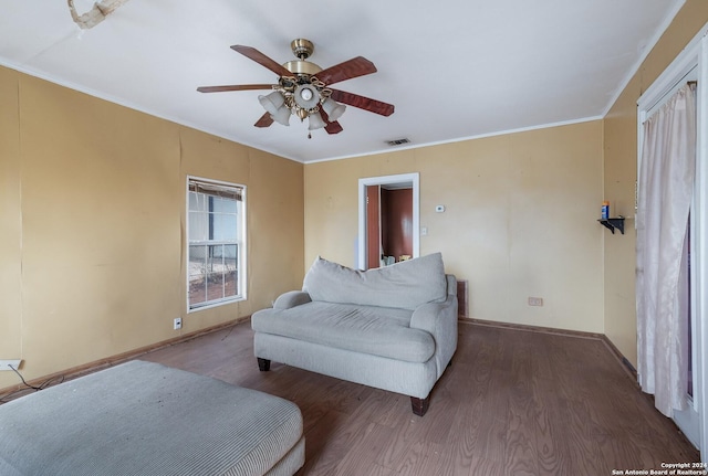 522 Ave B, Poteet, TX 78065 - sitting room with a ceiling fan, wood finished floors, baseboards, and crown molding
