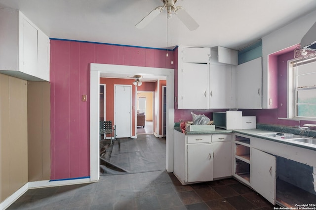 522 Ave B, Poteet, TX 78065 - kitchen with white cabinetry, ceiling fan, and a sink