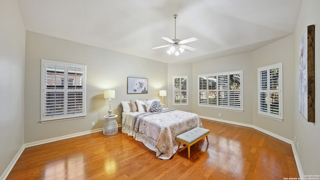 bedroom with light hardwood / wood-style floors and ceiling fan