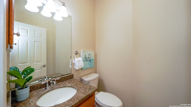 bathroom with toilet and vanity