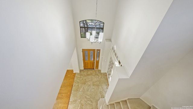 entryway featuring a notable chandelier and a high ceiling