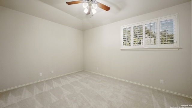 carpeted spare room with ceiling fan