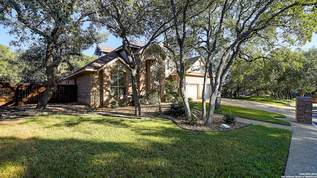 view of front of home featuring a garage and a front lawn