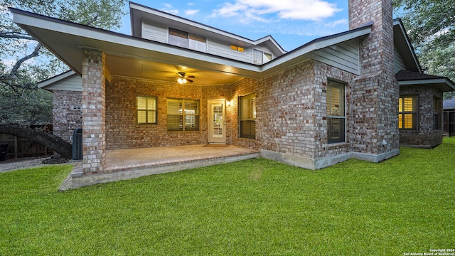 back of house featuring a patio area, a yard, and ceiling fan