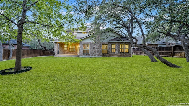 back of house featuring a lawn