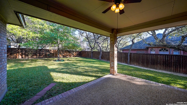 view of yard with ceiling fan