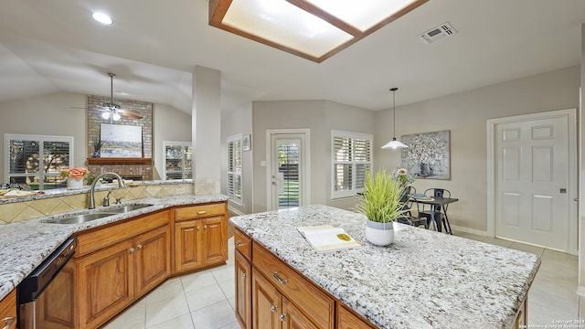 kitchen with dishwasher, pendant lighting, lofted ceiling, and sink