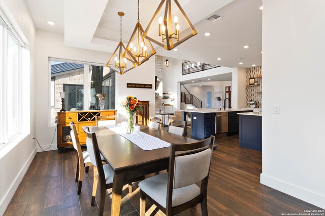 dining room with dark hardwood / wood-style floors, a healthy amount of sunlight, and sink