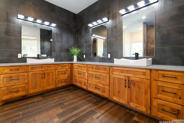 bathroom with tile walls, vanity, and hardwood / wood-style flooring