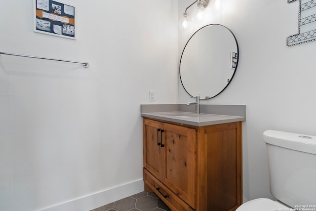 bathroom with tile patterned floors, vanity, and toilet