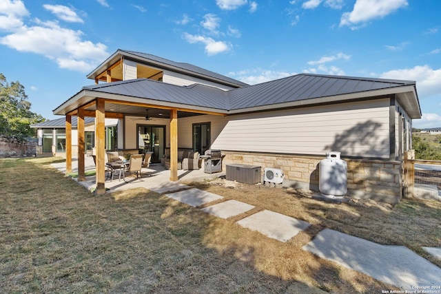 back of property featuring a lawn, central AC unit, ceiling fan, and a patio