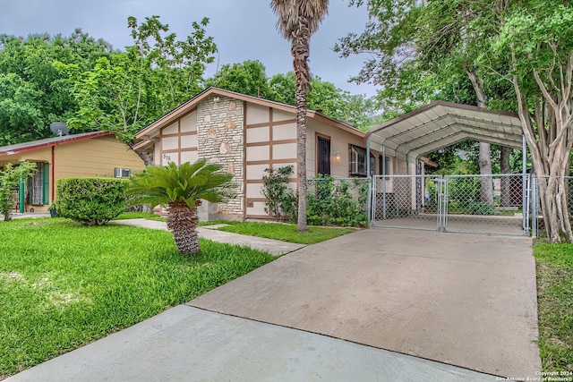 view of front facade with a carport and a front yard