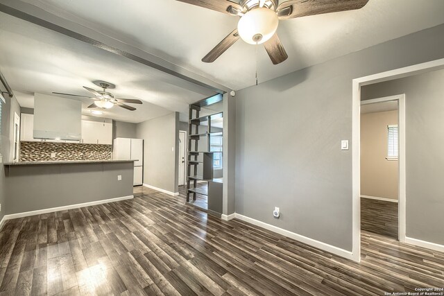 unfurnished living room featuring dark hardwood / wood-style flooring