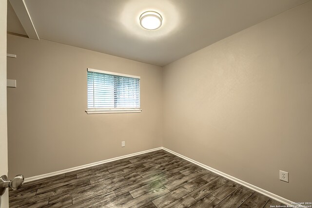 empty room with dark wood-type flooring