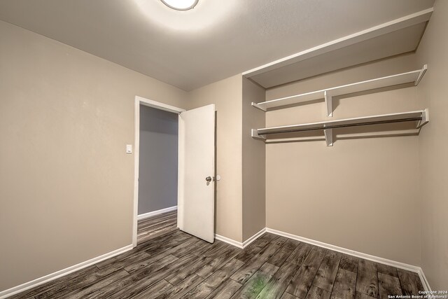 unfurnished bedroom with a closet and dark hardwood / wood-style flooring