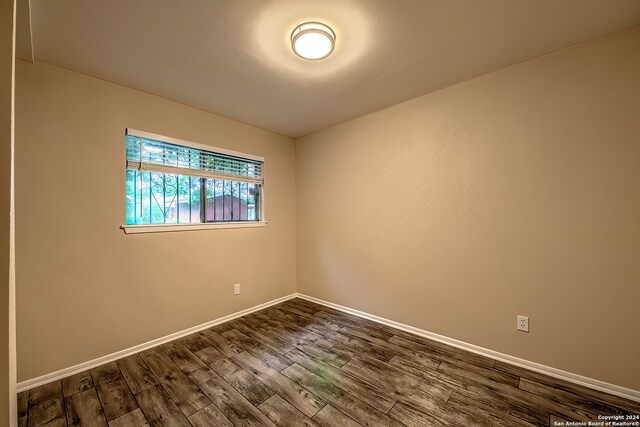 spare room with dark hardwood / wood-style floors