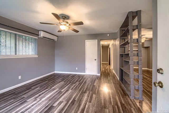 empty room with a wall unit AC, ceiling fan, and dark hardwood / wood-style flooring