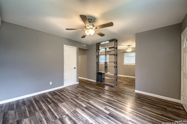 unfurnished bedroom with ceiling fan and dark hardwood / wood-style floors