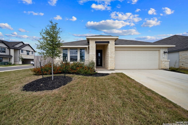 prairie-style home with a garage and a front yard