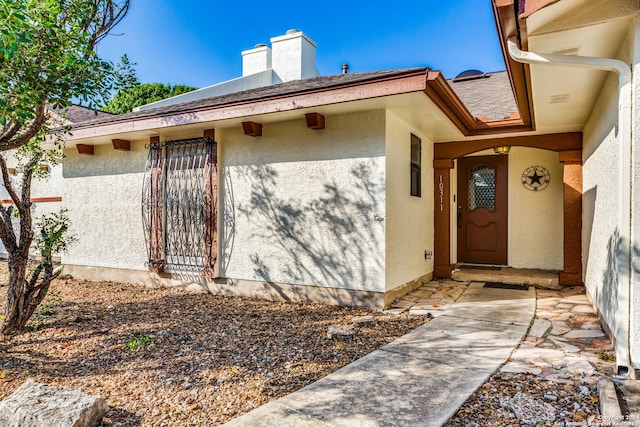 10311 Grand Cir, San Antonio, TX 78239 - property entrance featuring a chimney and stucco siding