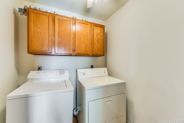 clothes washing area with cabinets, ceiling fan, and washing machine and clothes dryer