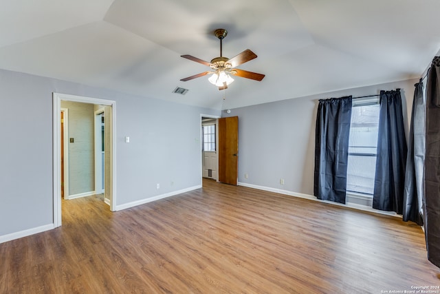 unfurnished room featuring light hardwood / wood-style flooring, ceiling fan, and vaulted ceiling