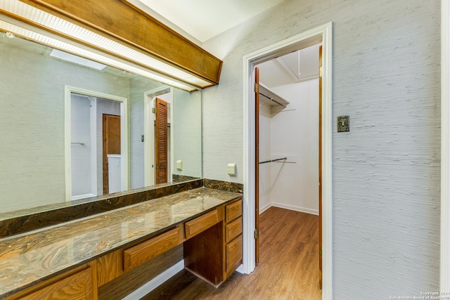 10311 Grand Cir, San Antonio, TX 78239 - bathroom with wood finished floors, vanity, and baseboards