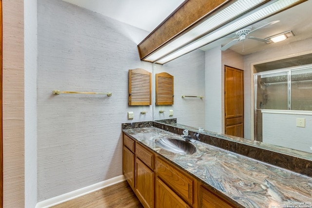 10311 Grand Cir, San Antonio, TX 78239 - full bath featuring a stall shower, baseboards, vanity, wood finished floors, and ceiling fan