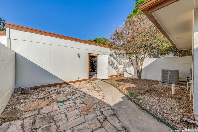 10311 Grand Cir, San Antonio, TX 78239 - property entrance with a patio, fence, and central AC unit