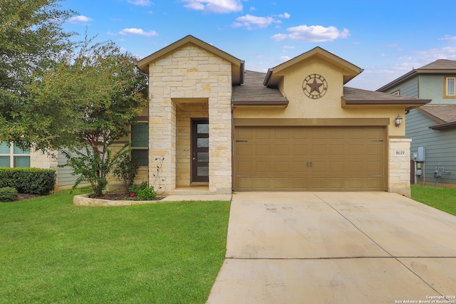 view of front of house with a garage and a front lawn