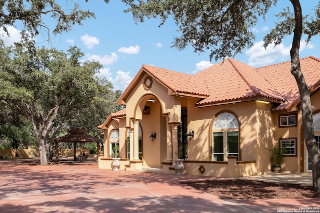 2301 Tanglewood, Weslaco, TX 78596 - mediterranean / spanish-style house featuring a gazebo, a tile roof, and stucco siding