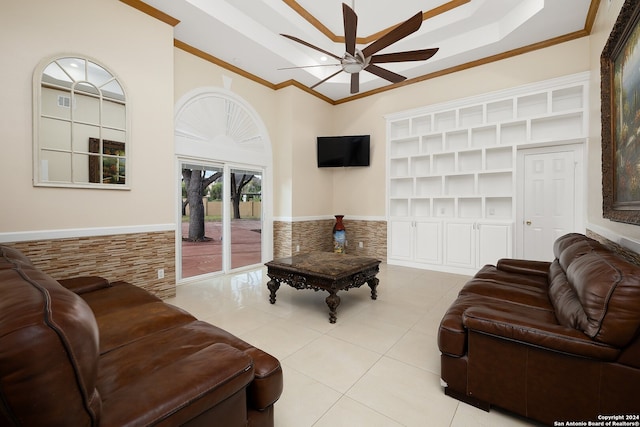 living room with ceiling fan, light tile patterned floors, crown molding, built in features, and tile walls