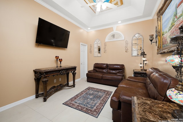 tiled living room with ceiling fan, crown molding, and a tray ceiling