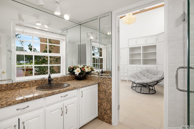 bathroom with vanity, tile patterned floors, and a shower with door