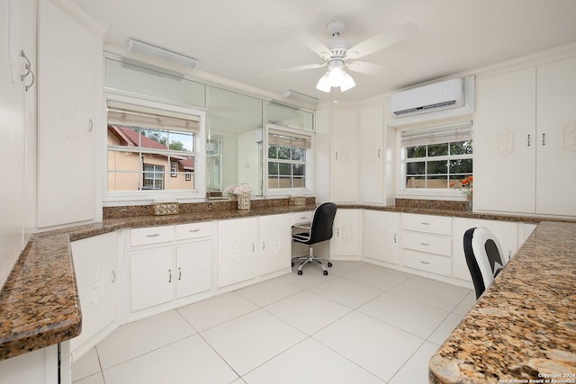 tiled home office featuring a wall mounted AC, built in desk, ceiling fan, and crown molding