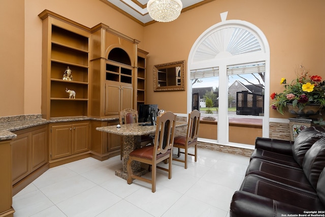 tiled home office with a notable chandelier and ornamental molding