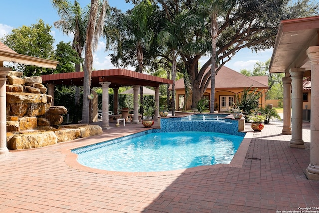 view of pool featuring central air condition unit, a patio area, french doors, and an in ground hot tub