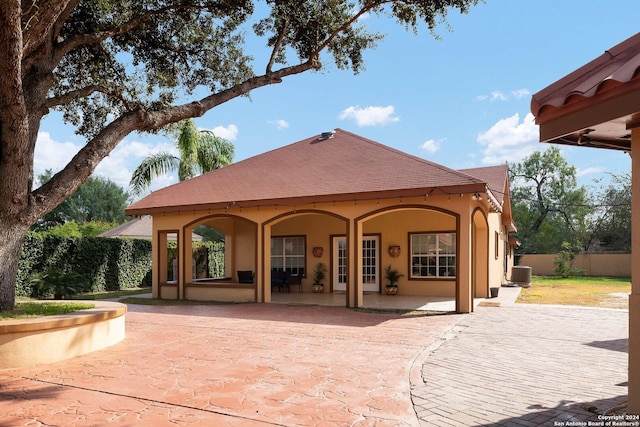 2301 Tanglewood, Weslaco, TX 78596 - rear view of property with stucco siding, central AC, and a patio area
