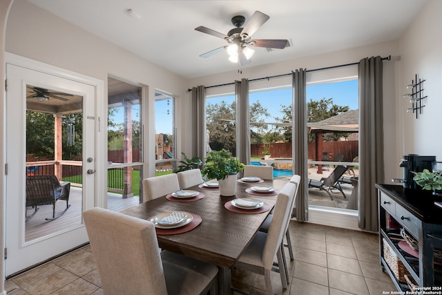 dining room with light tile patterned floors, ceiling fan, and plenty of natural light