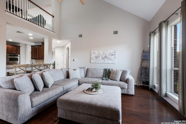 living room with high vaulted ceiling and dark hardwood / wood-style floors