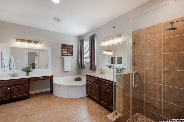 bathroom with tile patterned flooring, vanity, and separate shower and tub